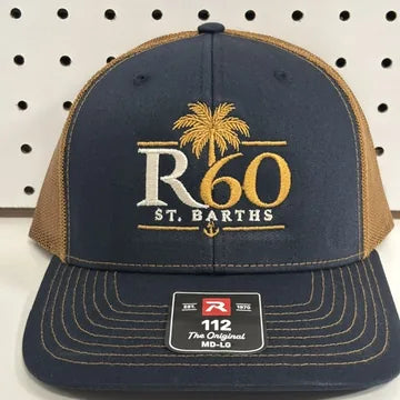 Real embroidery proof: a gold palm tree logo stitched on a navy and caramel Richardson 112 trucker hat