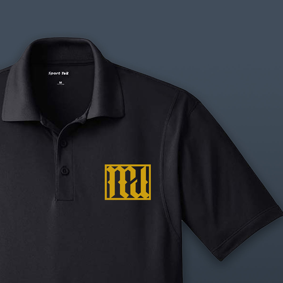 Mockup of a black Sport-Tek polo with the gold MyCali Designs logo on the chest