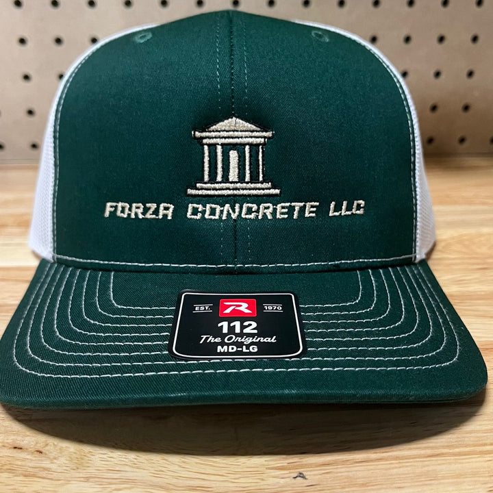 Embroidered concrete contractor logo on a dark green and white Richardson 112 trucker hat
