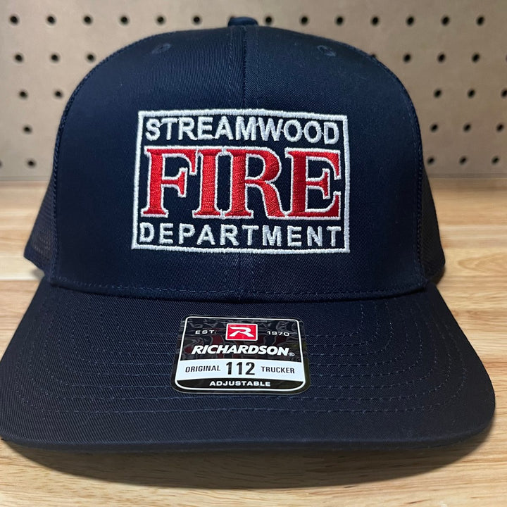 Embroidered fire department logo on a navy Richardson 112 trucker hat
