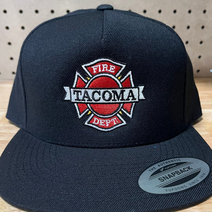 Embroidered fire department logo on a black flat bill snapback