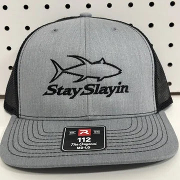 Real embroidery proof: a black fish outline and script lettering stitched on a heather gray Richardson 112 trucker hat